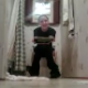 A guy video-records his girlfriend from a crack under the door as she poops in the bathroom. She is quite aware of his activities and protests loudly. No audible pooping sounds.